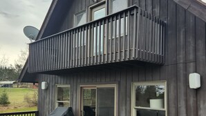 A modern two-story house with a wooden exterior, a balcony with vertical siding, and a satellite dish. - Dream Country Getaway 27 Acres in Conesus, NY! New Game Room! (Conesus)