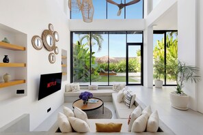 Luxury Villa, Garden View | Living area | 50-inch LED TV with digital channels, Netflix, streaming services - Aquamarine II By BREIG (Canggu)