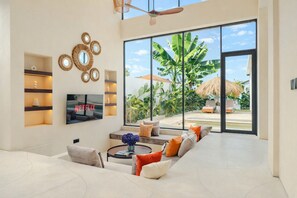 Luxury Villa, Pool View | Living area | 50-inch LED TV with digital channels, Netflix, streaming services - Aquamarine II By BREIG (Canggu)