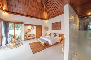 A spacious bedroom with a large bed, a glass shower, and a view of the outdoors. - Dewi Kunti Villa (Sebatu)