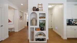 A hallway with a central display of various items including pottery, a ladder, and a plant. - Zion view~Hot Tub~Fire Pit~Sauna~Stargazing (Apple Valley)