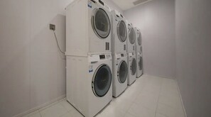 A laundry room with four stacked washing machines. - Lemon Hotel-Hangzhou West Lake (Hangzhou)