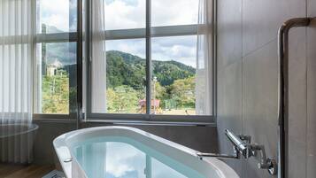 Suite, Non Smoking | Bathroom | Separate tub and shower, free toiletries, hair dryer, bathrobes