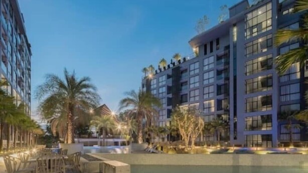 A modern hotel with a pool area, outdoor seating, and palm trees. - 600m to beach New City gate P214 c60 (Kamala)