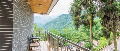 A balcony with a view of a mountainous landscape.