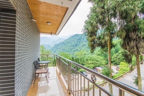 A balcony with a view of a mountainous landscape.