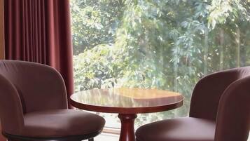 A room with two brown leather chairs and a small wooden table.