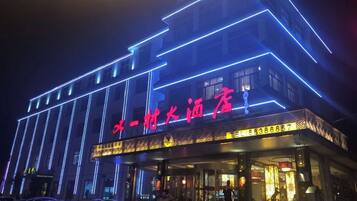 A hotel with illuminated signage and a modern facade.