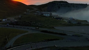 A sunset over a hilly landscape with a road curving through the foreground. - Appartement 6 Places à 150m des Pistes (Arette)