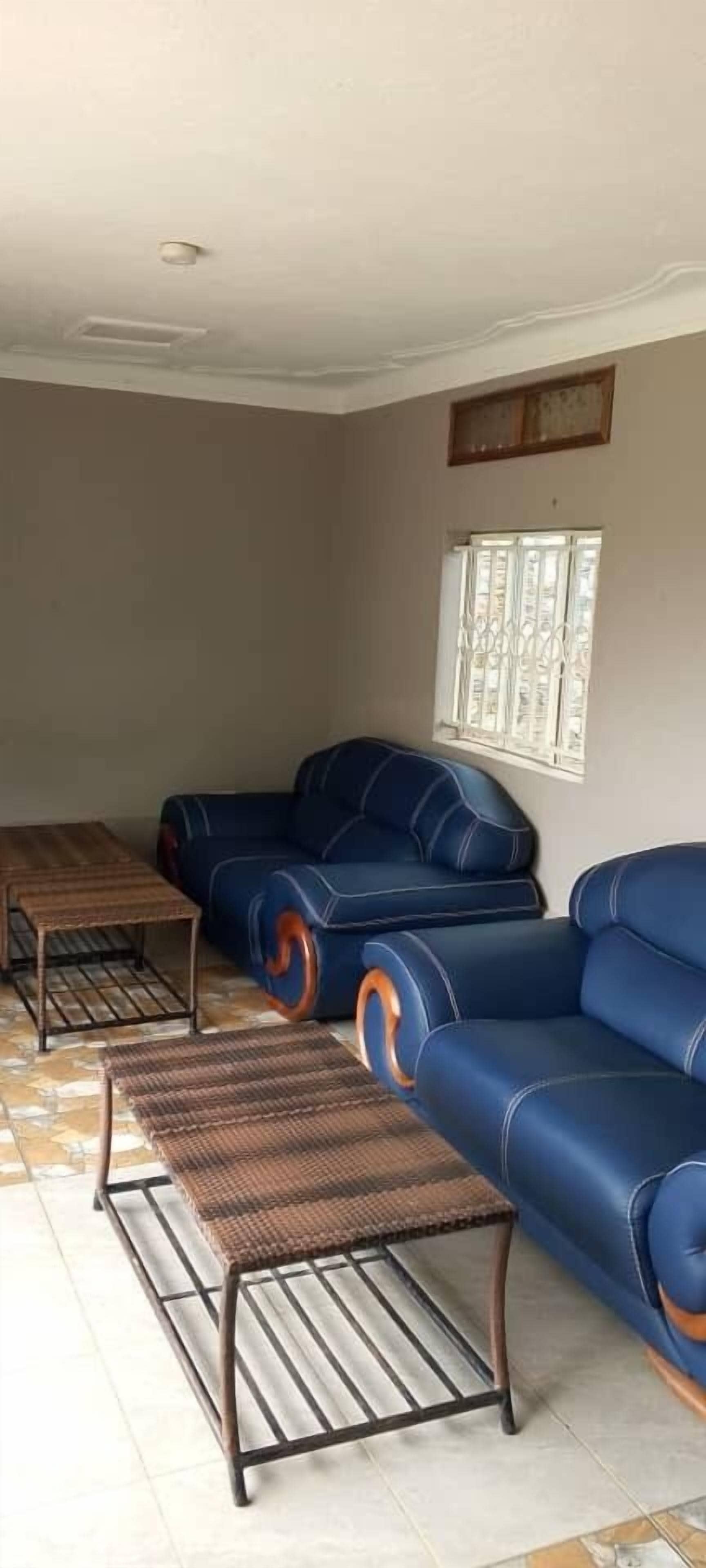 A living room with a sofa, a coffee table, and a patterned rug.