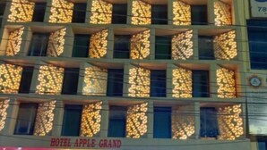 A hotel with a sign reading "Hotel Apple Grand" and "The Annakoot Family Restaurant." - Hotel Apple  (Indore)