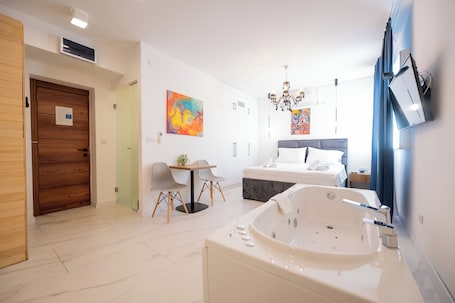 Deluxe Suite, Sauna, Ground Floor | 1 bedroom, in-room safe, desk, laptop workspace