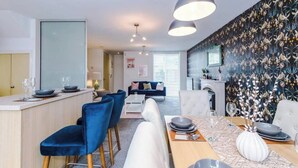A modern interior with a dining area, kitchen, and living space.