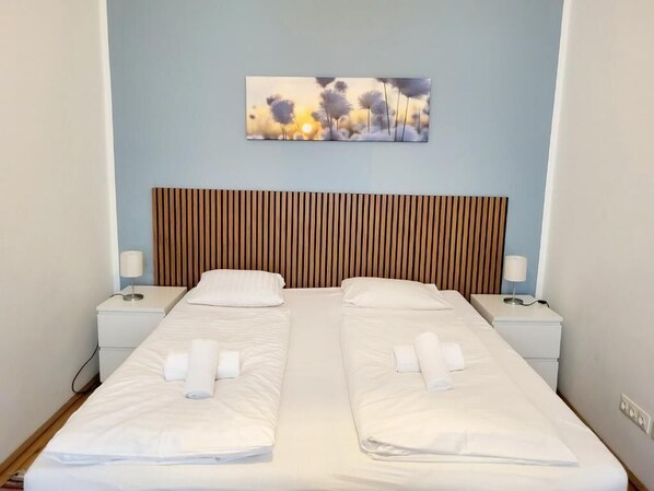 Relax in a stylish room with a double bed, bedside tables, and a wall-mounted artwork.