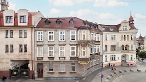 A historic building with multiple stories, large windows, and a prominent corner entrance.