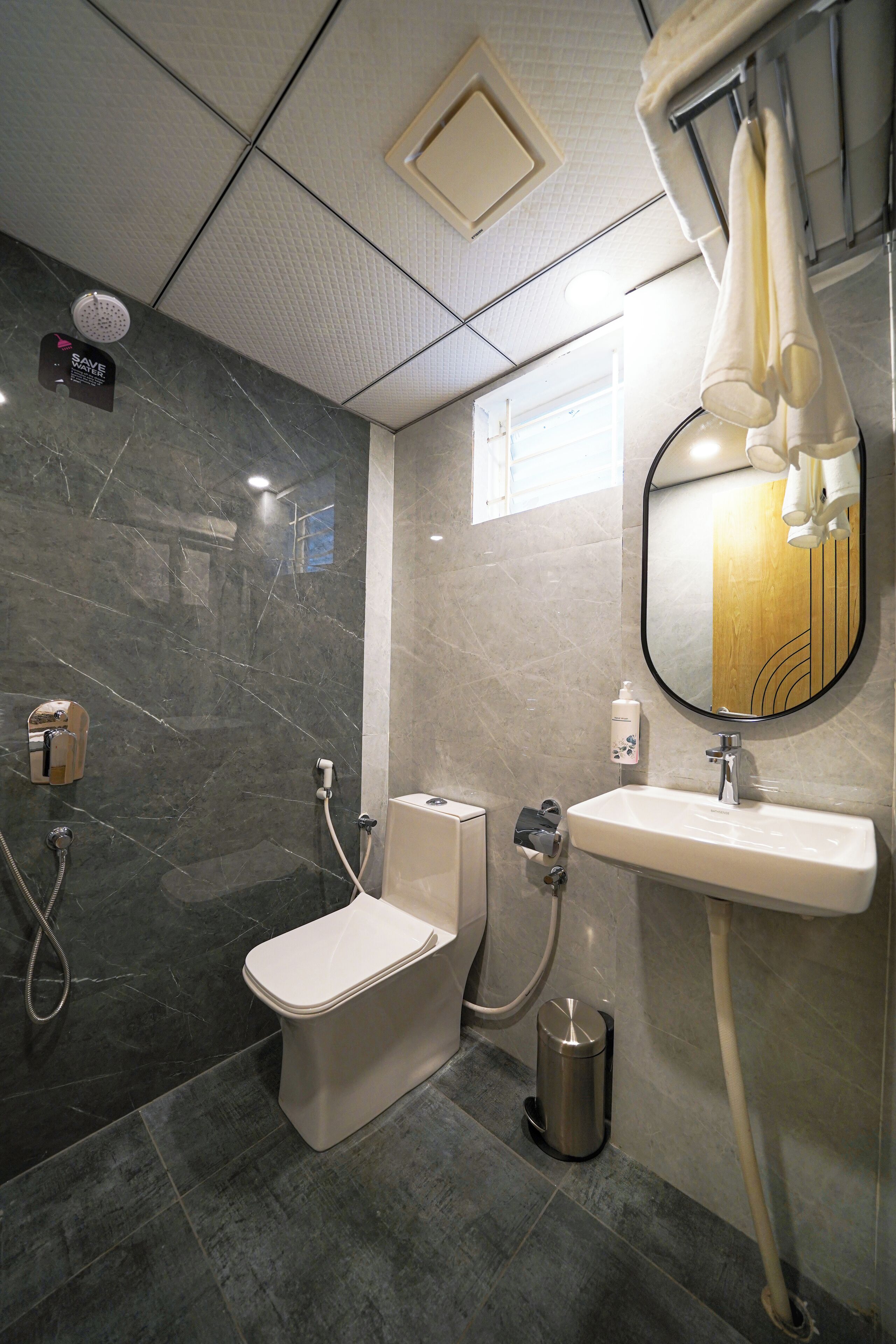 A bathroom with a toilet, sink, and shower.