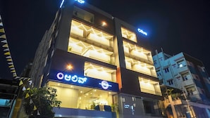 A multi-story hotel with illuminated signage and balconies. - Olive Hotel Kundalahalli by Embassy Group (Bengaluru)