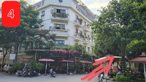 A multi-story building with balconies, outdoor seating, and potted plants. - Ruby Sun Home (Hanoi)