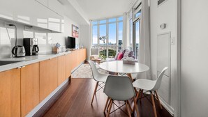 A modern kitchen with a dining area, large windows, and a city view. - GLOBALSTAY. Panoramic 1 Bedroom Condo in Downtown (Toronto/Canada)