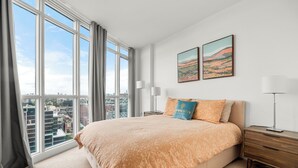 A bedroom with a large bed, two bedside tables, a nightstand, and a window with a city view. - GLOBALSTAY. Panoramic 1 Bedroom Condo in Downtown (Toronto/Canada)