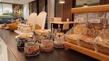A breakfast buffet with various food items and a coffee station.
