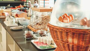 Un bufé de desayuno con diferentes alimentos y acompañamientos.