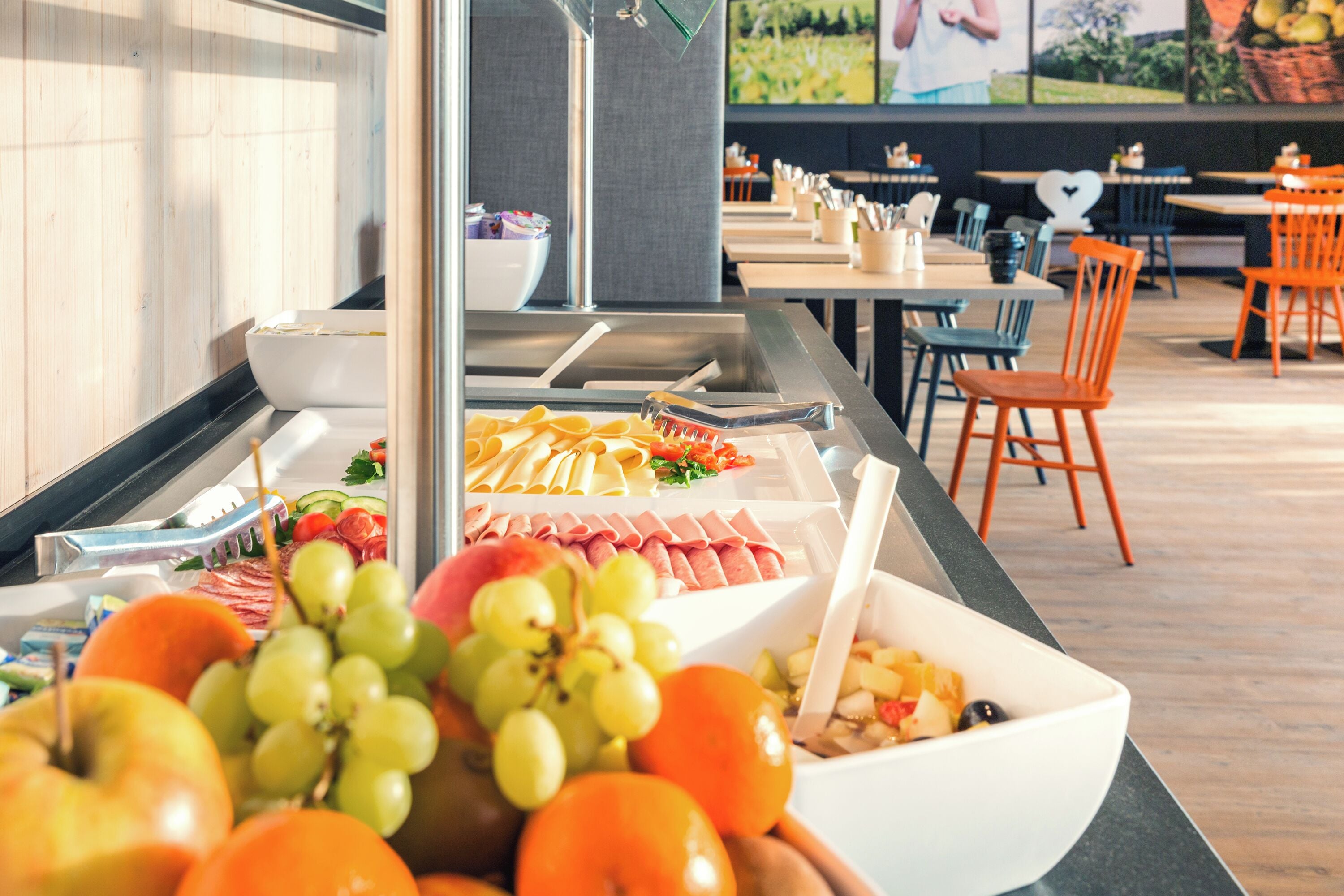 A buffet with various fruits, cheeses, and meats.