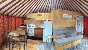 A cozy interior with a kitchen area, a dining table, and a sofa. - Canyon Creek Resort (Winters)
