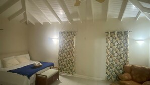 A room with a bed, a sofa, a small table, a ceiling fan, and curtains. - 4-bedroom villa in wonderful Oistins with pool (Oistins)