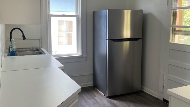 A kitchen with a stainless steel refrigerator, a window, and a sink. - 2Bed 1Bath 1930s KC Home off I-35 ~ Walking Distance to Coffee & Breakfast (Kansas City)