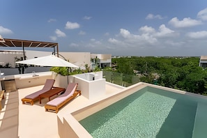 A rooftop pool area with lounge chairs and a pergola. - oasis yaaxlum (Tulum)