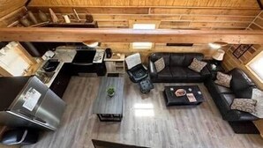 A compact living space with a kitchenette, a sofa set, and a dining area. - Deer View at Patoka Lake (Birdseye)