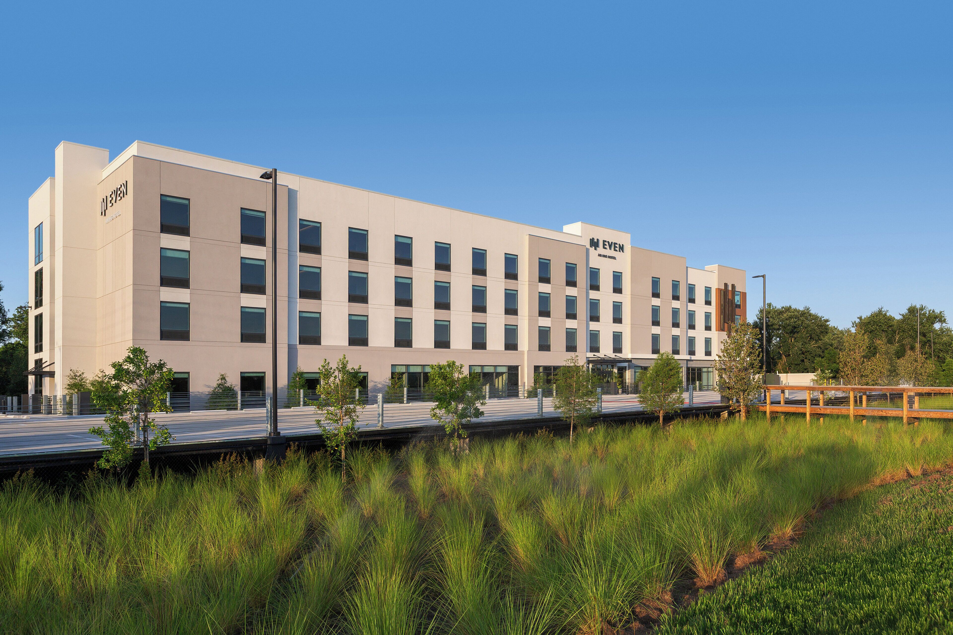 A modern building with a flat roof, multiple windows, and a sign reading "EVEN".