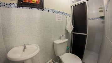 A bathroom with a sink, toilet, and shower.