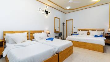 Family Quadruple Room, Patio, Garden View | In-room safe, desk, laptop workspace, blackout drapes