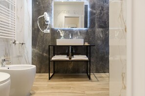 A bathroom with a white sink, a mirror, a towel rack, and a toilet. - Domus Augustea - Augusto 1 (Rome)
