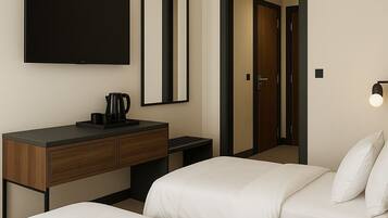 A hotel room with a bed, a bedside table, a mirror, a TV, and a door.
