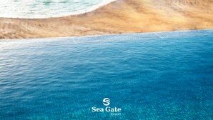 A clear view of a swimming pool with a logo for Sea Gate Resort.