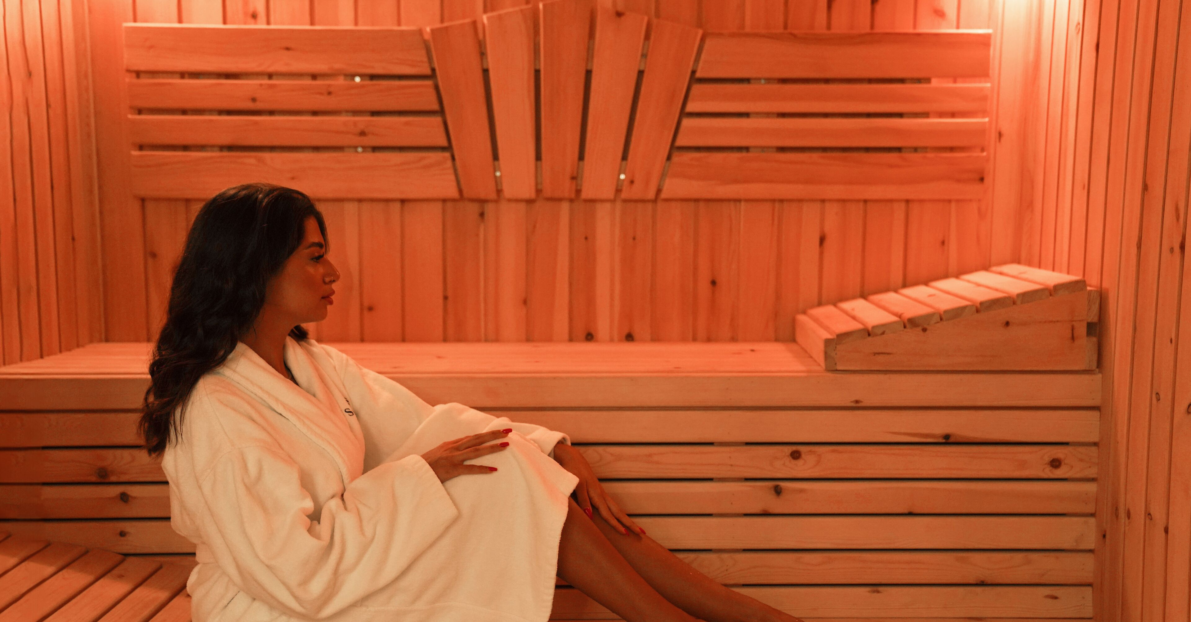 A sauna with wooden benches and a sloped seating area.