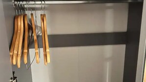 A closet with wooden hangers and a metal rod. - 4 Guests - 10min Airport - N E C - Jaguar (Solihull)