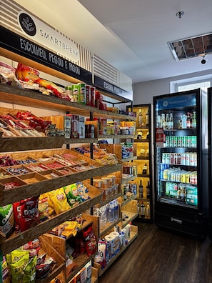 A snack and beverage section with shelves stocked with various snacks and a refrigerated display case.