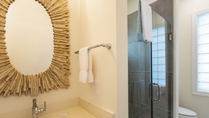 A bathroom with a marble sink, a glass shower enclosure, and a toilet. - Sorrento Cabana: 1-Bedroom Cabana Near Vanderbilt Beach – Perfect for a Tranquil Beachside Escape (Naples)