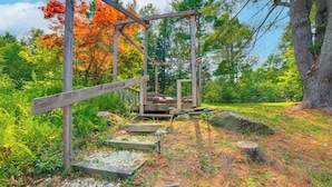A wooden structure with a bench in a forested area. - Peaceful Brookside Getaway ~10 Mi to Okemo Slopes! (Chester)