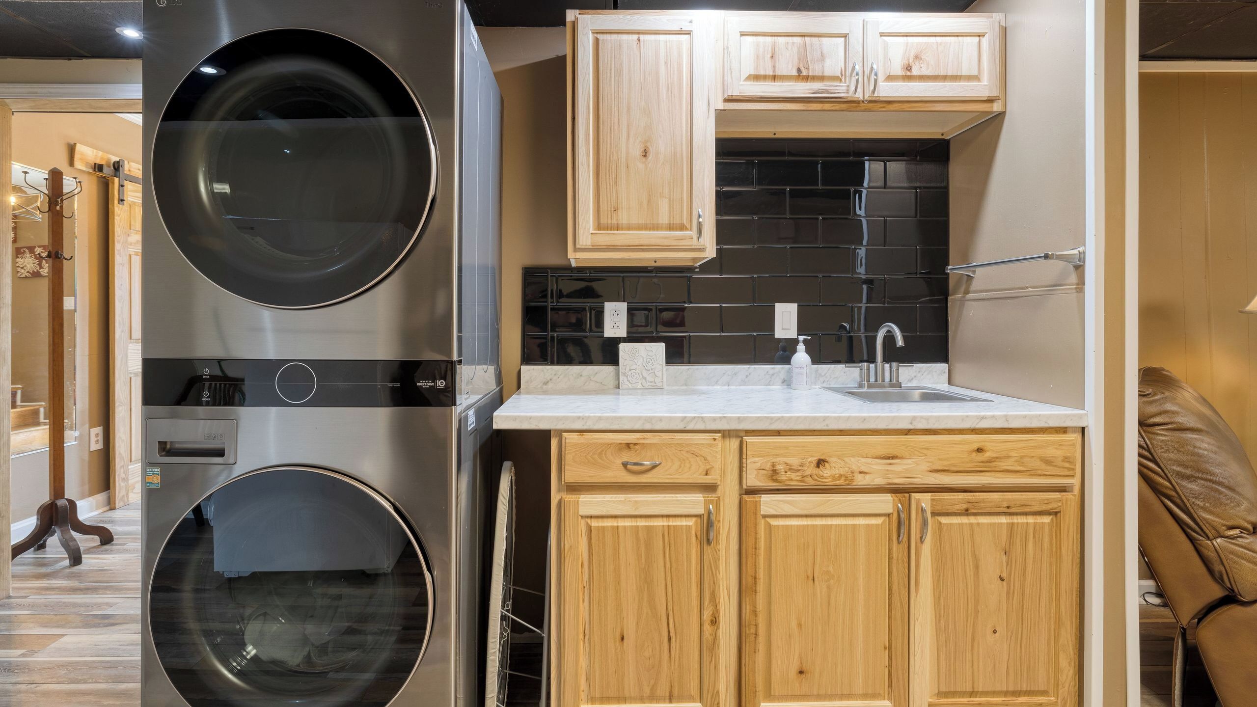 A compact kitchen with wooden cabinets, a built-in oven, and a sink.