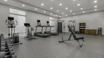 A gym with treadmills, a stationary bike, and weight machines.