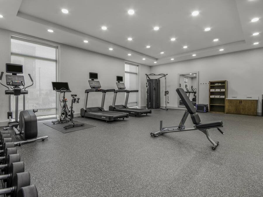 A gym with treadmills, a stationary bike, and weight machines.