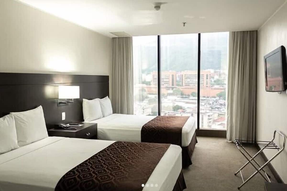 Deluxe Room, City View | In-room safe, desk, laptop workspace, iron/ironing board