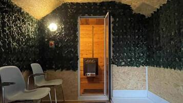 Relax in a serene sauna with a bench and seating area.
