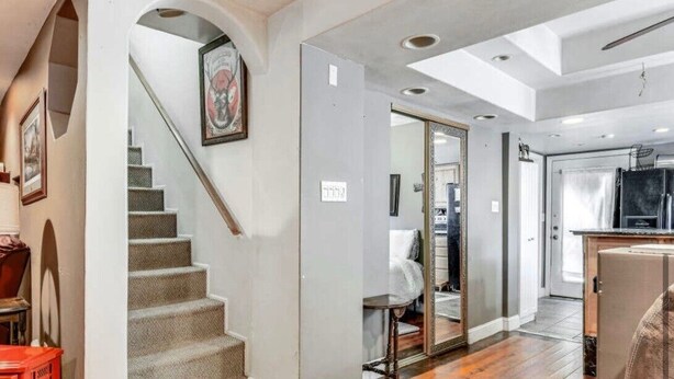 A modern interior with a staircase, a kitchen area, and a living space.