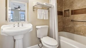 A bathroom with a sink, toilet, and bathtub. - Cypress Cottage R4 (Lafitte)